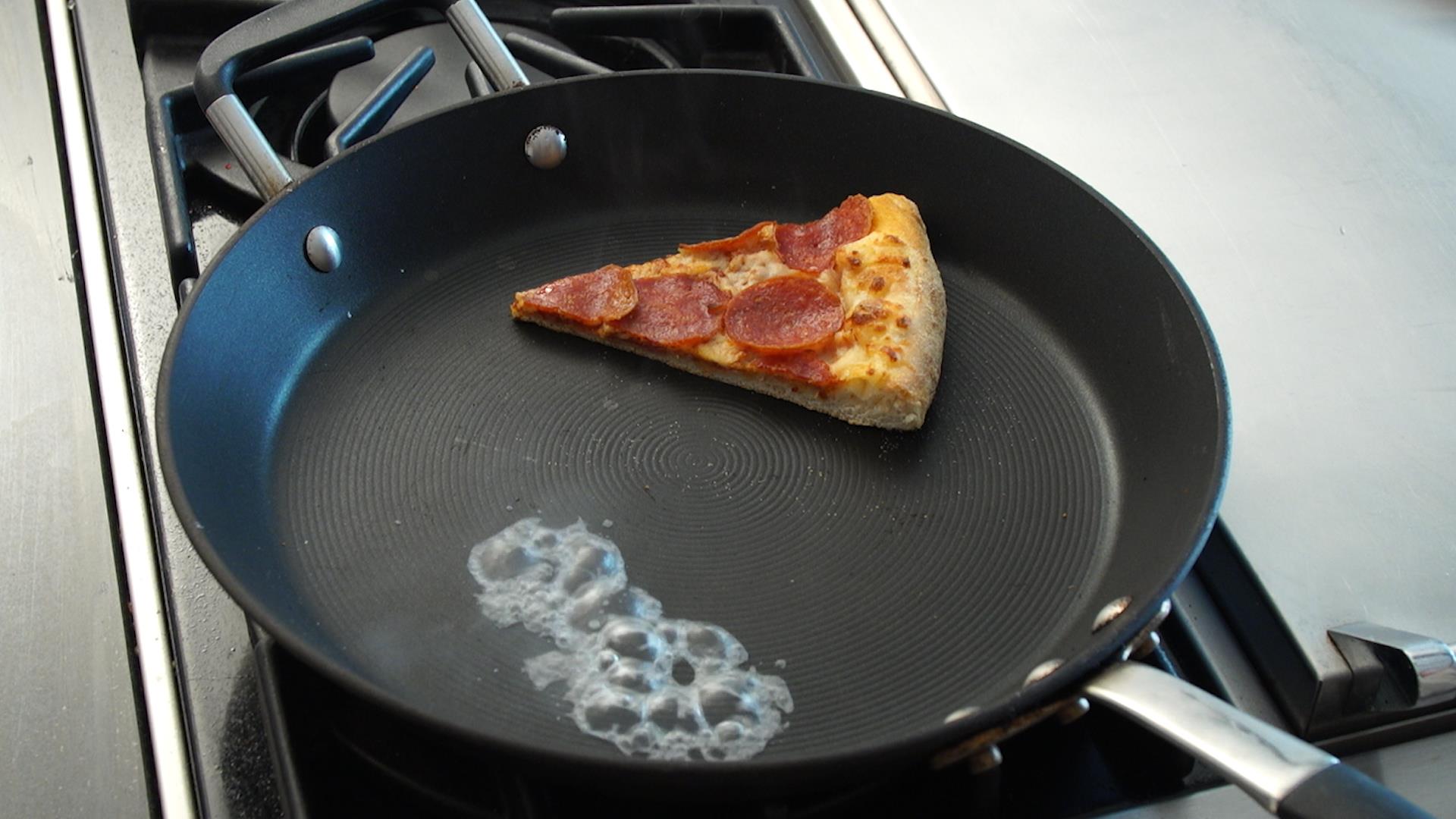 Local Pepperoni pizza slice re-heat on top of skillet or a pan