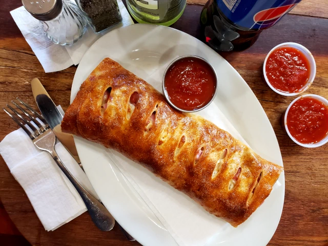 Fresh Stromboli with extra marinara sauce for pick up and delivery